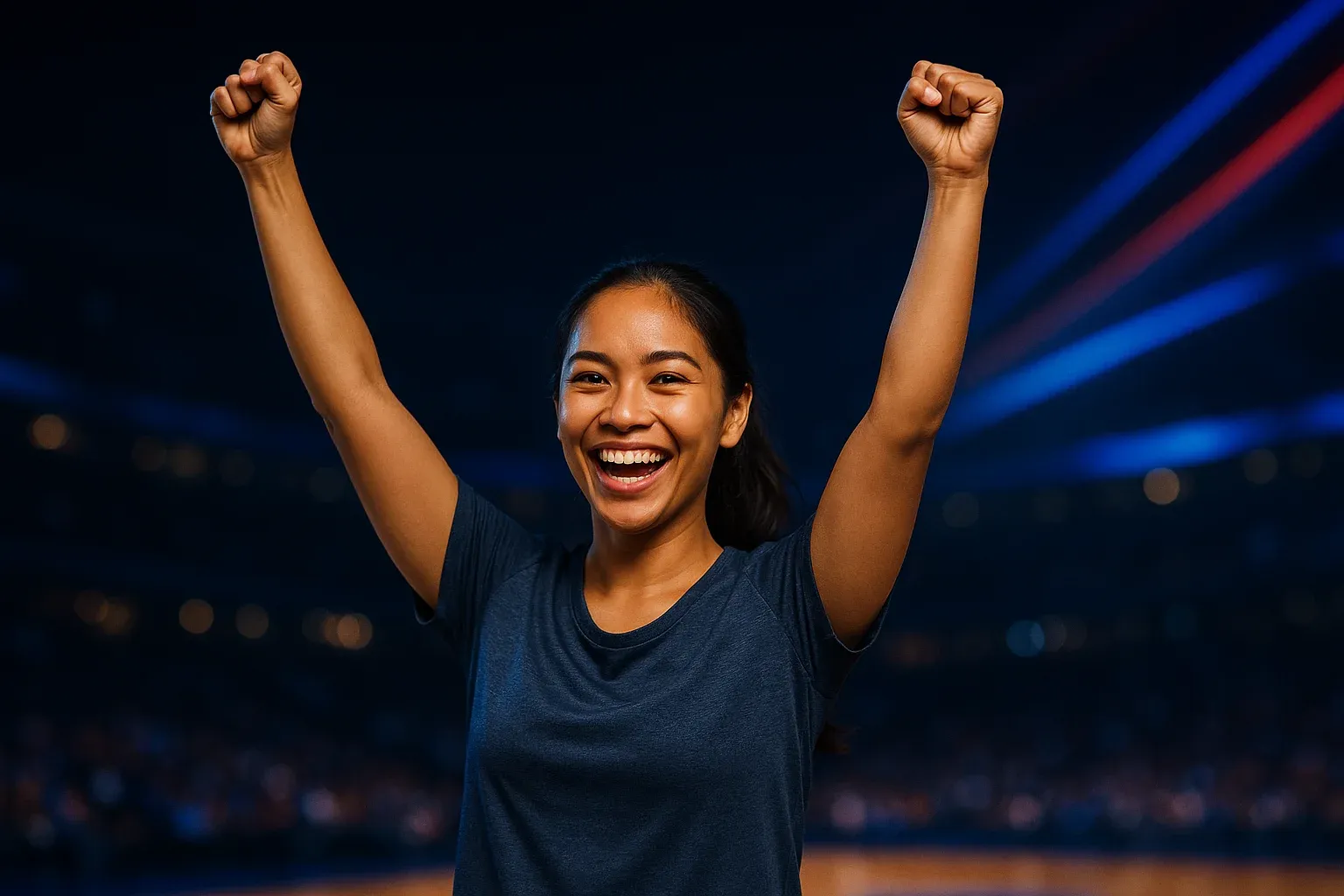 Excited Filipino woman in sportswear celebrating victory in blurred arena